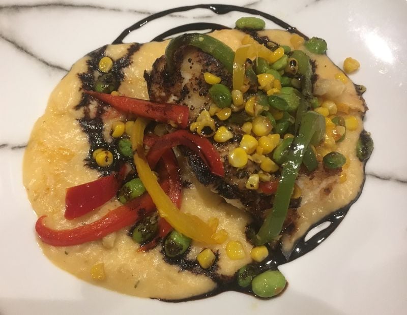 The pan seared grouper is served with sweet corn and garden pepper ragout and crawfish mash. Photo: Jennifer Brett