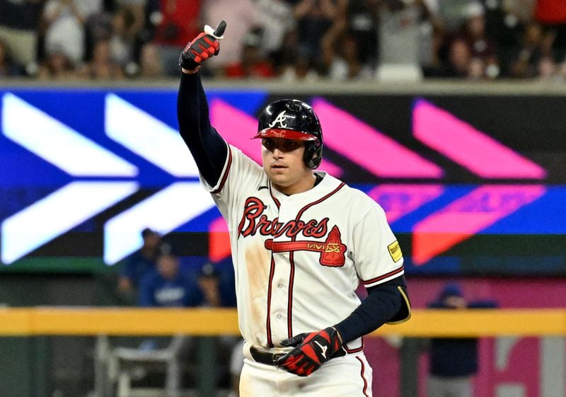 Atlanta Braves third baseman Austin Riley (27) celebrates after hitting a double during the ninth inning at Truist Park. (Hyosub Shin / Hyosub.Shin@ajc.com)