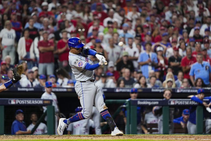 New York Mets' Mark Vientos hits a two-run home run against Philadelphia Phillies pitcher Matt Strahm during the ninth inning of Game 2 of a baseball NL Division Series, Sunday, Oct. 6, 2024, in Philadelphia. (AP Photo/Matt Slocum)