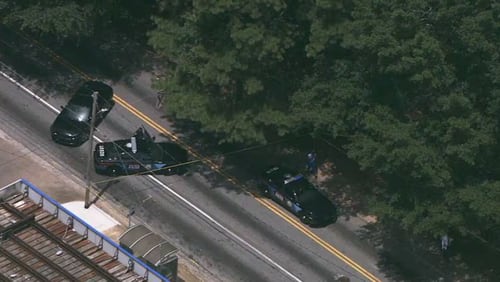 Atlanta police squad cars gathered at the intersection of Cleveland Avenue and Browns Mill Road after three people were found shot in the area.