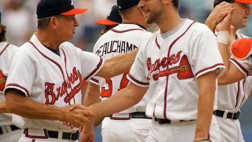 John Smoltz gets a handshake from Atlanta Braves manager Bobby Cox after completing his fourteenth straight win.