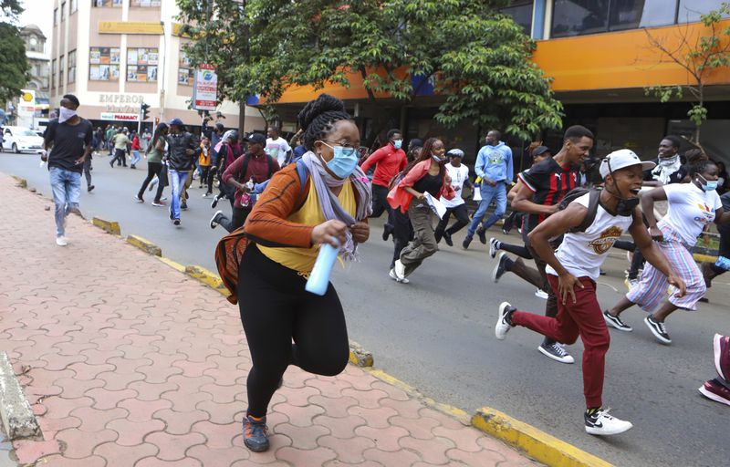 Demonstrators run from police during a protest over proposed tax hikes in a finance bill that is due to be tabled in parliament in Nairobi, Kenya, Thursday, June 20, 2024. (AP Photo/ Andrew Kasuku)