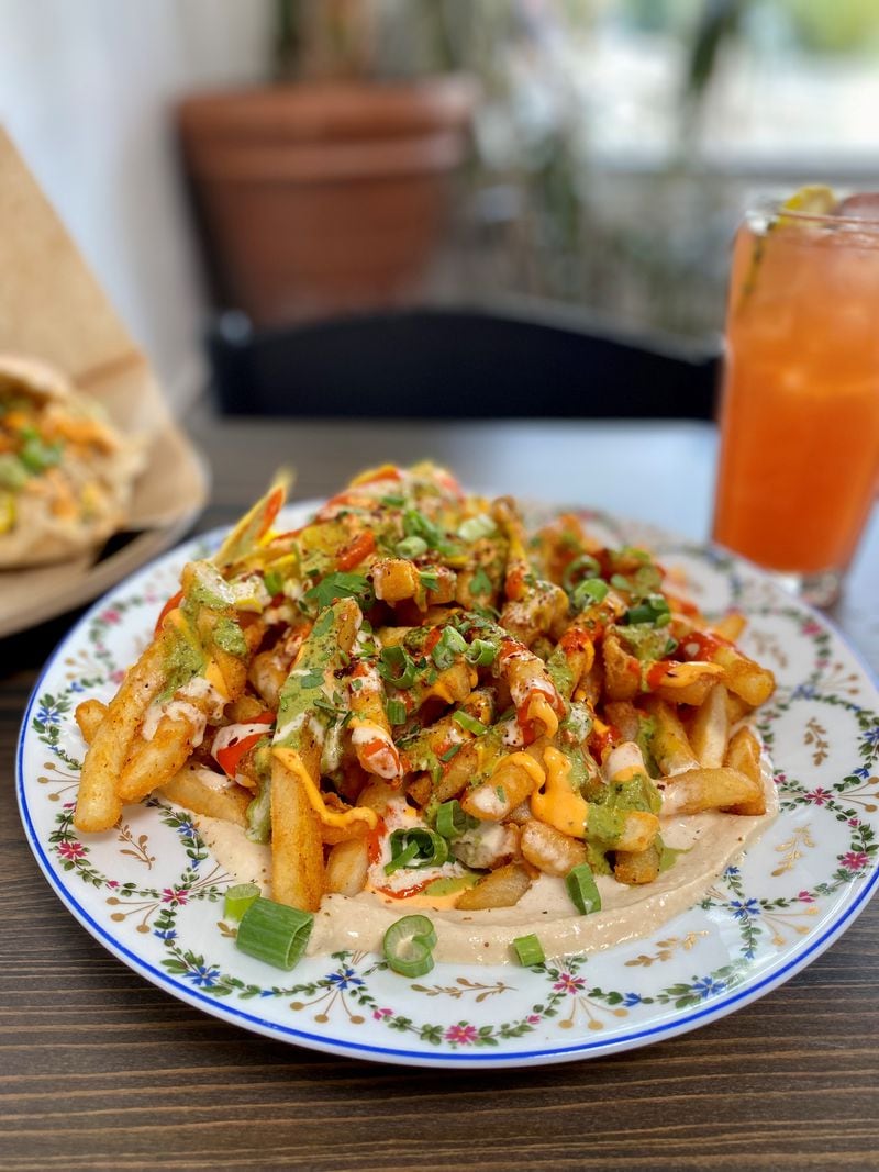 The Daily Chew’s loaded fries — with hummus, labneh, pickled veggies, house sauces, sumac and za'atar — are delicious and a great plate to share.
Wendell Brock for The Atlanta Journal-Constitution