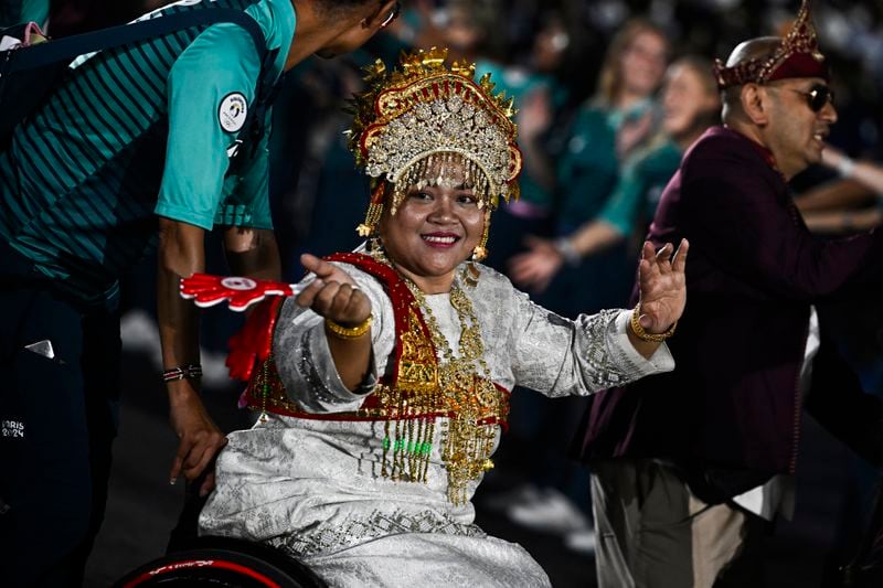 Indonesia's delegation arrives during the Parade of Nations as part of the Paris 2024 Paralympic Games Opening Ceremony at the Place de la Concorde in Paris, France, Wednesday Aug. 28, 2024. (Julien De Rosa/Pool Photo via AP)