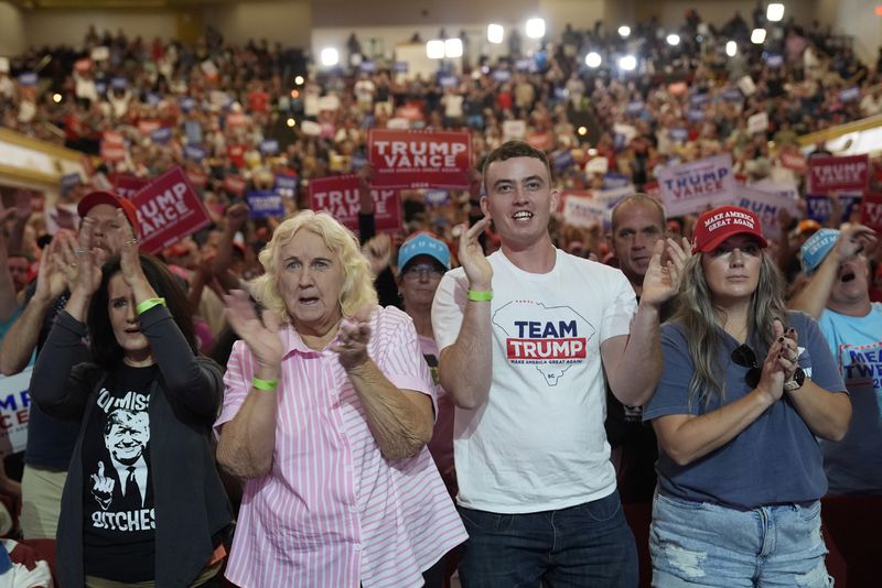 Supporters arrive before Republican presidential nominee former President Donald Trump speaks at a campaign rally in Asheville, N.C., Wednesday, Aug. 14, 2024. (AP Photo/Matt Rourke)