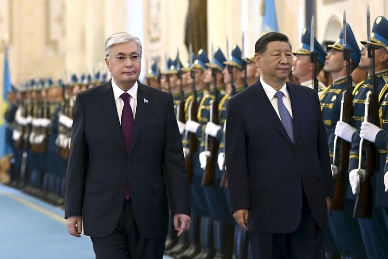 In this photo released by Kazakhstan's Presidential Press Office, President Kassym-Jomart Tokayev, left, and Chinese President Xi Jinping attend an official welcome ceremony at the palace in Astana, Kazakhstan, Wednesday, July 3, 2024. (Kazakhstan's Presidential Press Office via AP)
