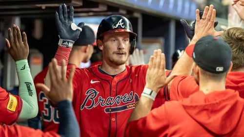 Atlanta Braves' Sean Murphy, center, celebrates in the dugout after hitting a two-run home run in the fourth inning of a baseball game against the Kansas City Royals, Friday, Sept. 27, 2024, in Atlanta. (AP Photo/Jason Allen)