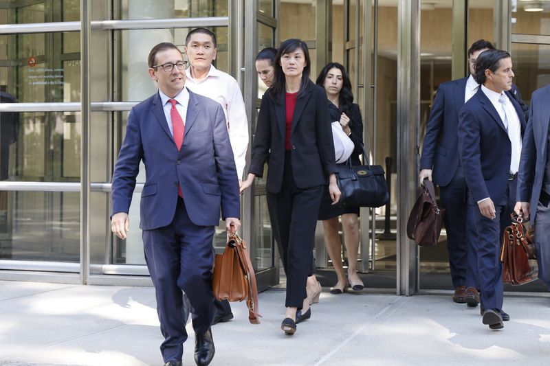 Former New York Governor Kathy Hochul aide Linda Sun, center, and her husband, Christopher Hu, second from left, leave Brooklyn Federal Court after their arraignment, Tuesday, Sept. 3, 2024, in New York. (AP Photo/Corey Sipkin)