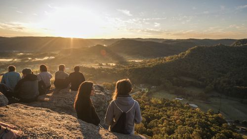 Students sit atop Indian Fort Mountain in Berea, Kentucky, during Berea College Mountain Day in Oct. 2023, an annual event held to celebrate the surrounding Appalachian region. The Partners for Rural Impact are taking a philanthropic model from Harlem and adapting it for Appalachian Kentucky. (Partners for Rural Impact via AP)