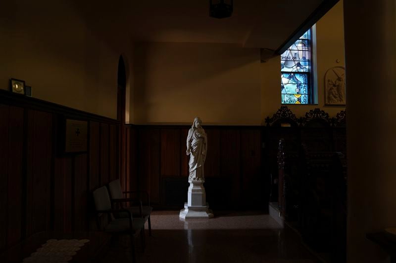 Light shines on a statue of Jesus in the chapel at the monastery of the Mount St. Scholastica Benedictine sisters in Atchison, Kan., Tuesday, July 16, 2024. (AP Photo/Jessie Wardarski)