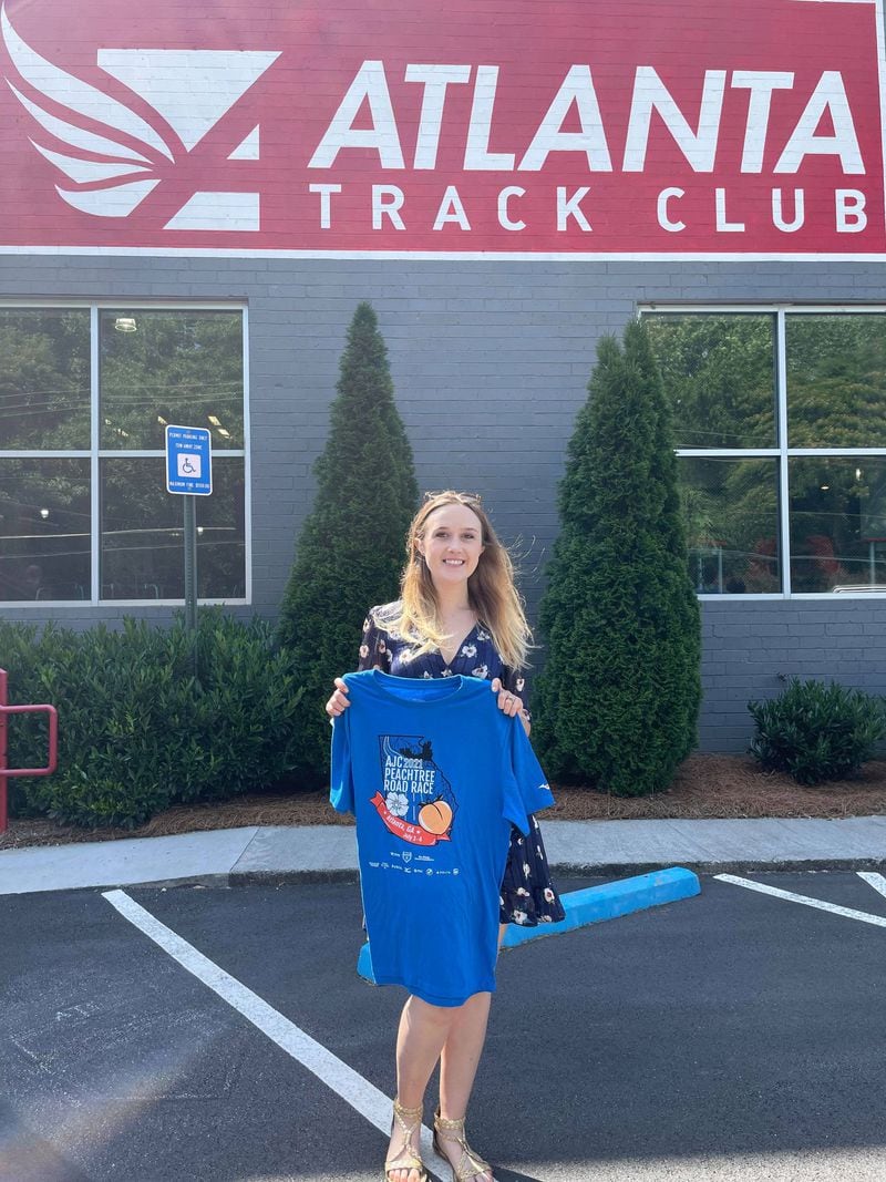 The Atlanta Track Club surprised the winning T-shirt designer, Leah Knighton, Tuesday morning.