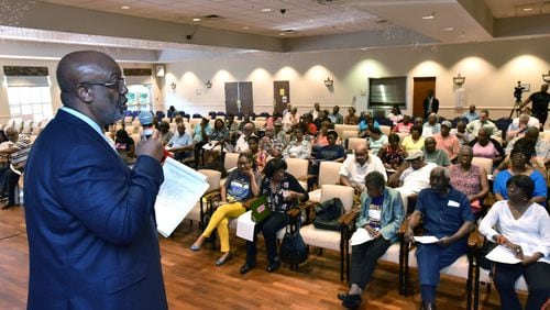 Dwight Robinson, Fulton County chief appraiser, speaks before Fulton County residents. The county plans to send property tax bills next month, and set its tax rate Wednesday. HYOSUB SHIN / HSHIN@AJC.COM