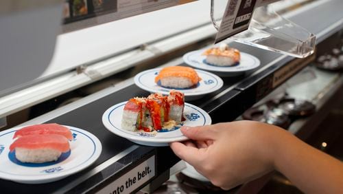 Sushi comes to customers on a conveyor belt at Kura Revolving Sushi. / Courtesy of Kura Revolving Sushi