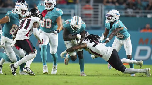 Kevin King (32) of the Atlanta Falcons tackles Malik Washington (83) of the Miami Dolphins during the second quarter in a preseason game at Hard Rock Stadium on Friday, Aug. 9, 2024, in Miami Gardens, Florida. (Rich Storry/Getty Images/TNS)