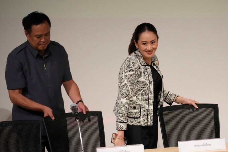 Leader of Pheu Thai Party, Paetongtarn Shinawatra, daughter of Thailand's former Prime Minister Thaksin Shinawatra, right, and coalition partners arrive for a press conference in Bangkok, Thailand, Thursday, Aug. 15, 2024. (AP Photo/Sakchai Lalit)