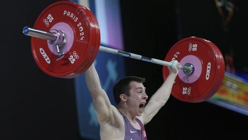 Hampton Morris of the United States competes during the men's 61kg weightlifting event at the 2024 Summer Olympics, Wednesday, Aug. 7, 2024, in Paris, France. (AP Photo/Kin Cheung)