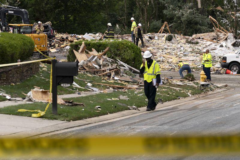 Crew workers remove the debris after a house exploded in Bel Air, Md. neighborhood on Sunday, Aug. 11, 2024. (AP Photo/Jose Luis Magana)