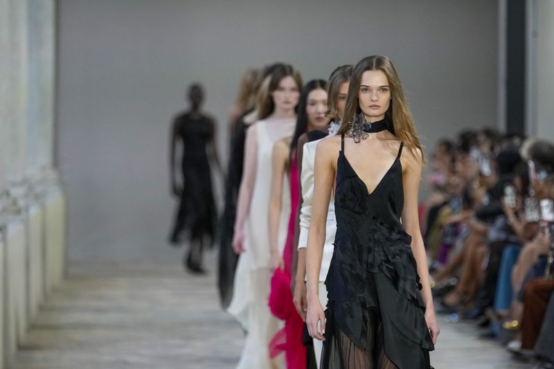 Models wear creations as part of the Alberta Ferretti Spring Summer 2025 collection, that was presented in Milan, Italy, Tuesday, Sept. 17, 2024. (AP Photo/Luca Bruno).