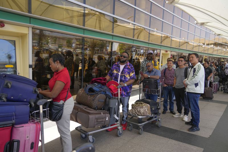 Stranded passengers wait for their delayed flights out of JKIA airport after flights were grounded following workers’ protesting a planned deal between the government and a foreign investor, in Nairobi, Kenya, Wednesday, Sept. 11, 2024. (AP Photo/Brian Inganga)