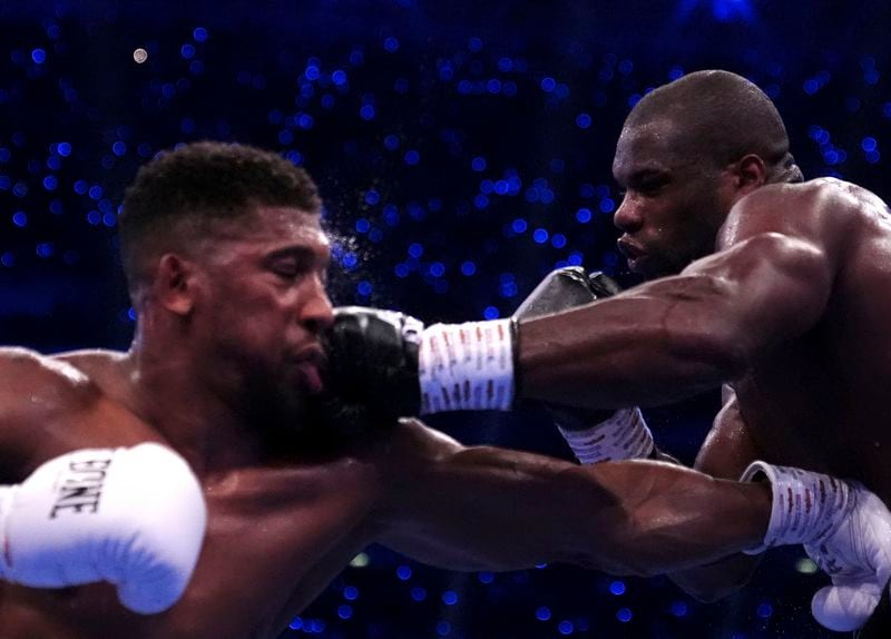 Anthony Joshua, left, and Daniel Dubois, fight in the IBF World Heavyweight bout at Wembley Stadium, in London, Saturday, Sept. 21, 2024. (Bradley Collyer/PA via AP)