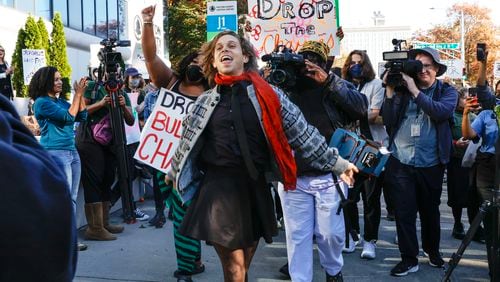 Jamie Marsicano dances into Fulton County Courthouse to be arraigned on Monday, Nov. 6, 2023. Marsicano is one of 61 defendants named in Georgia Attorney General Chris Carr’s RICO indictment against Atlanta Public Safety Center protestors.  (Natrice Miller/ Natrice.miller@ajc.com)