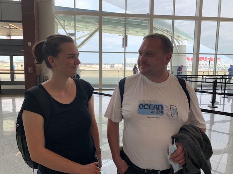 This couple who hoped to return to Europe were among passengers who went to Hartsfield-Jackson International Airport Saturday after their flights were canceled. They hoped to talk to someone who could rebook their flights. Otherwise, the airport’s international terminal was largely empty on Saturday. (Photo: Yamil Berard/AJC)
