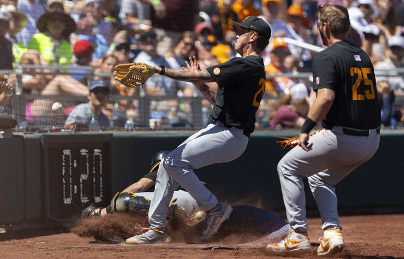 Tennessee's Aaron Combs, top left, reaches for but misses a foul ball hit by Texas A&M alongside teammates Cal Stark, bottom left, and Blake Burke, right, in the fifth inning of Game 2 of the NCAA College World Series baseball finals in Omaha, Neb., Sunday, June 23, 2024. (AP Photo/Rebecca S. Gratz)