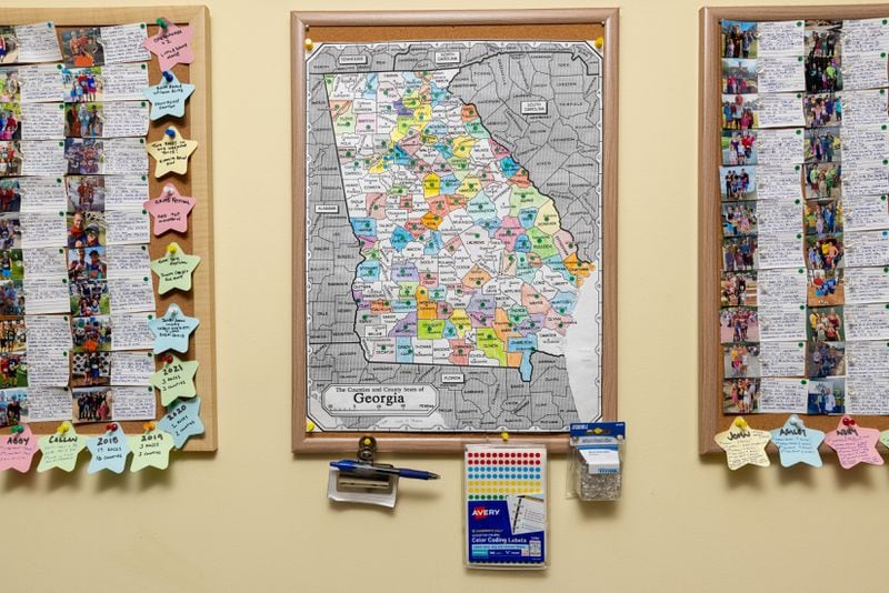 A map of the Coleman family's races hangs in their Decatur home on Thursday, May 23, 2024. The family aims to run a race in every county in Georgia. (Irvin Temker/AJC)