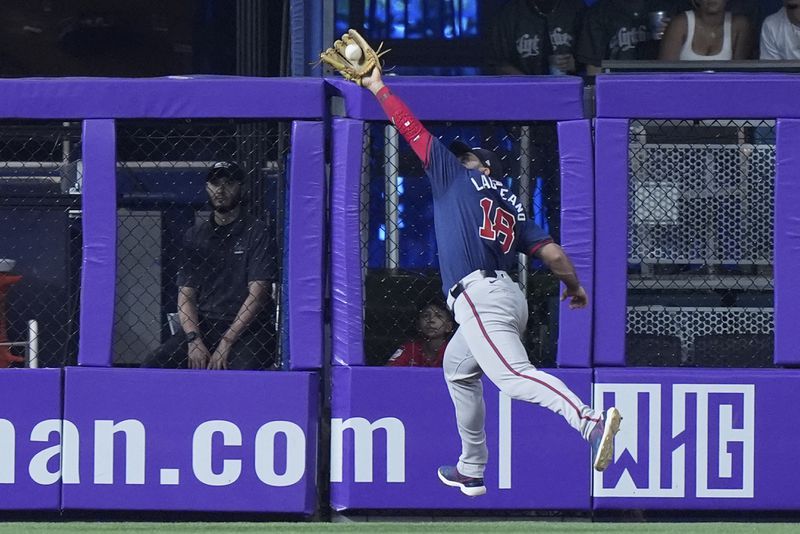 Atlanta Braves left fielder Ramón Laureano catches a ball hit by Miami Marlins' Jake Burger during the sixth inning of a baseball game, Sunday, Sept. 22, 2024, in Miami. (AP Photo/Wilfredo Lee)