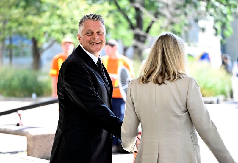 Former vice-admiral Haydn Edmundson, left, leaves the courthouse in Ottawa after being found not guilty of sexual assault and an indecent act, Monday, Sept. 16, 2024, in Ottawa. (Justin Tang/The Canadian Press via AP)