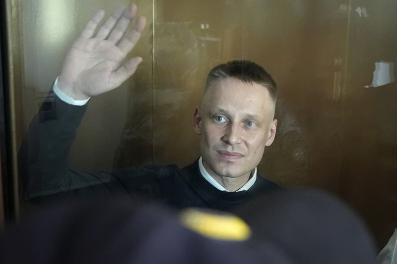 Russian journalist Konstantin Gabov accused of working for a group founded by the late Russian opposition politician Alexei Navalny, stands in a defendant's cage of the Nagatinsky District Court in Moscow, Russia, on Wednesday, Oct. 2, 2024. (AP Photo)