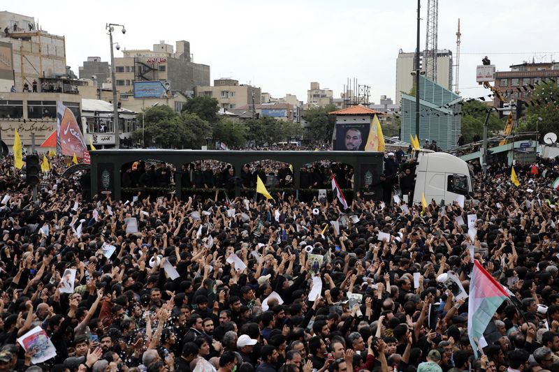 Mourners surround a truck carrying the flag-draped coffins of the President Ebrahim Raisi, and his companions who were killed in a helicopter crash on Sunday, during their funeral ceremony in the city of Mashhad, Iran, Thursday, May 23, 2024. Iran on Thursday prepared to inter its late president at the holiest site for Shiite Muslims in the Islamic Republic, a final sign of respect for a protégé of Iran's supreme leader killed in a helicopter crash earlier this week. (Mohammad Hasan Salavati, Shahraranews via AP)