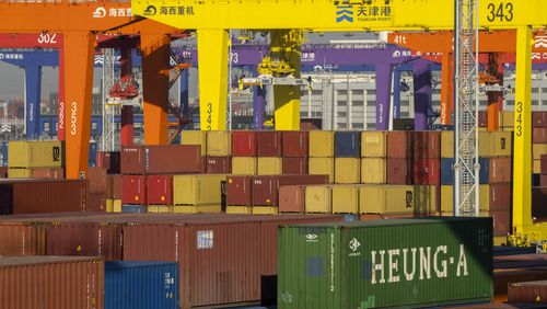 FILE - Shipping containers are stacked at a port in Tianjin, China, Monday, Jan. 16, 2023. (AP Photo/Mark Schiefelbein, File)