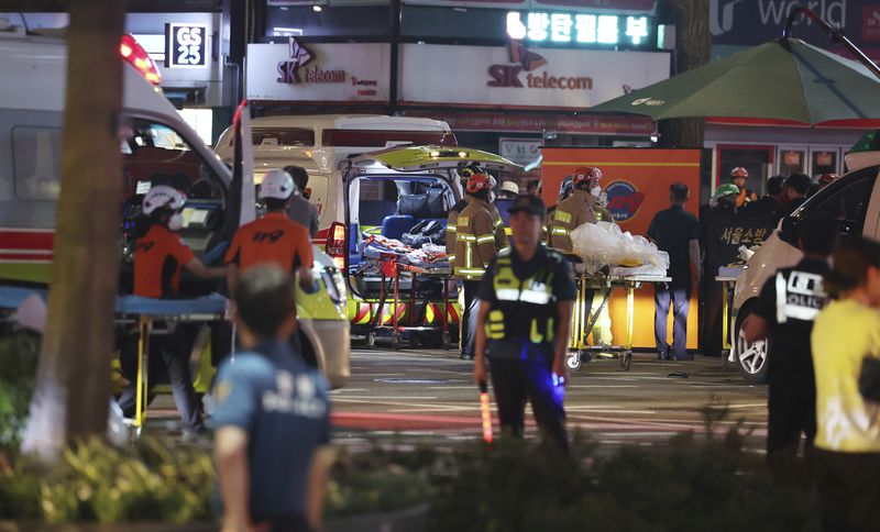 Rescuers and police officers arrive at the scene of a car accident near Seoul City Hall in downtown Seoul, South Korea, Monday, July 1, 2024. A car slammed into pedestrians in central Seoul on Monday night, killing nine people and injuring four others, officials said. (Seo Dae-yeon/Yonhap via AP)