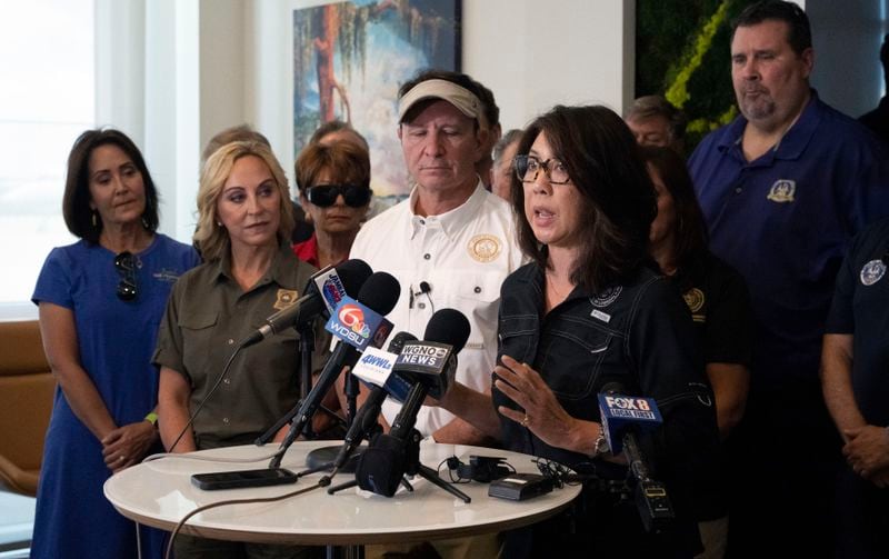 Louisiana Governor Jeff Landry, center, stands alongside Jefferson Parish President Cynthia Lee Sheng as she speaks about the impacts of Hurricane Francine during a meeting at New Orleans International Airport, Friday, Sept. 13, 2024, in Kenner, La. (Hilary Scheinuk/The Advocate via AP, Pool)