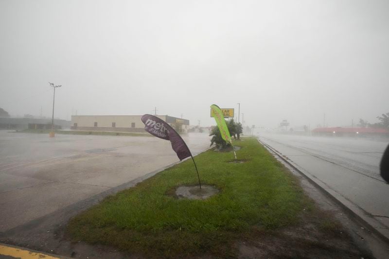 Signage bends in the wind as Hurricane Francine passes through Morgan City, La., Wednesday, Sept. 11, 2024. (AP Photo/Gerald Herbert)