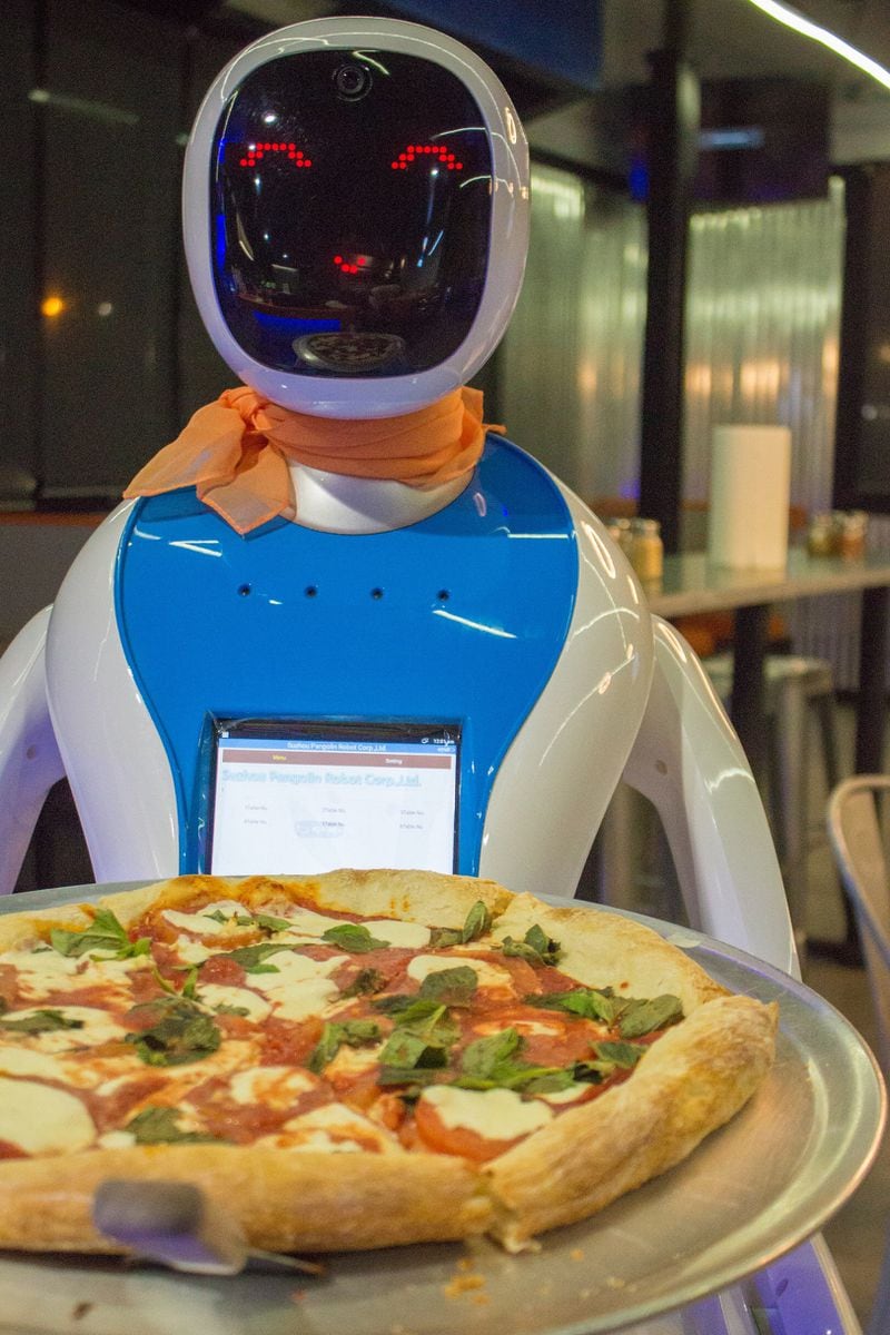 Robot servers are part of the attraction at Big Bang Pizza, located at 3043 Buford Highway in Brookhaven.