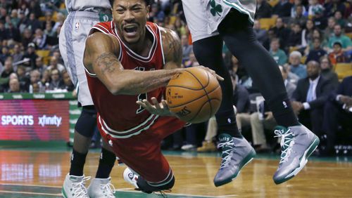 FILE -Chicago Bulls guard Derrick Rose falls after being tripped while driving against the Boston Celtics in the first half of an NBA basketball game in Boston, Nov. 28, 2014. (AP Photo/Elise Amendola, File)