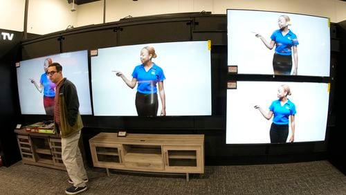 FILE - A customer turns away after looking at big-screen televisions in a Best Buy store Nov. 21, 2023, in southeast Denver. (AP Photo/David Zalubowski, File)