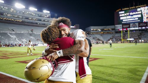 Boston College quarterback Thomas Castellanos, right, celebrates after his team defeated Florida State in an NCAA college football game, Monday, Sept. 2, 2024, in Tallahassee, Fla. (AP Photo/Colin Hackley)