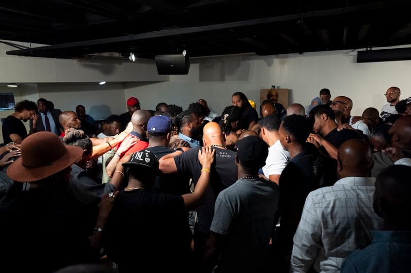 Attendees gather and pray during a Black Man Lab meeting to discuss the candidacy of Vice President Kamala Harris, Monday, July 22, 2024, in Atlanta. (AP Photo/Stephanie Scarbrough)