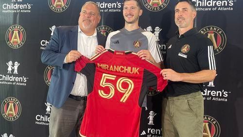 Atlanta United's Alexey Miranchuk (center), was introduced on Tuesday. He is seen here with President Garth Lagerwey (left), and Vice President Carlos Bocanegra (right). (Photo by Doug Roberson/The Atlanta Journal-Constitution)