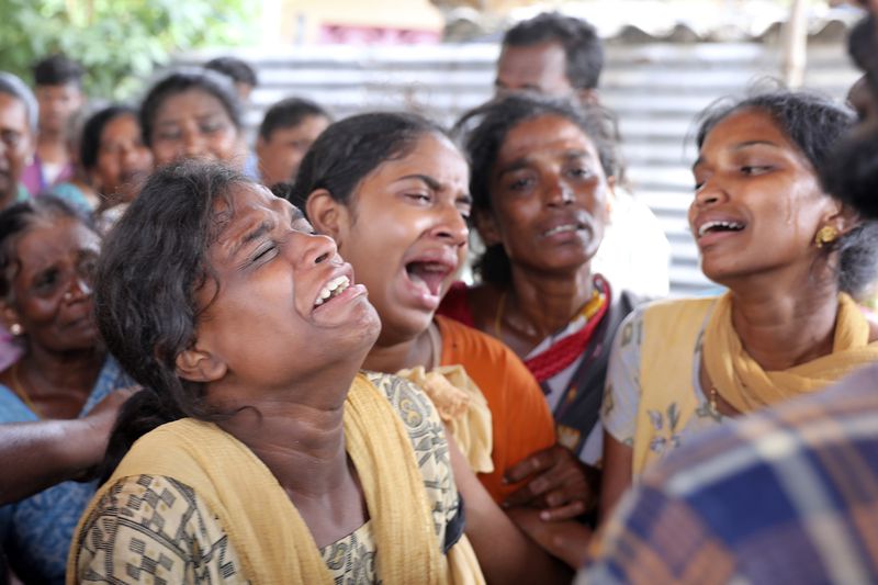 Relatives of a person, who died after drinking illegally brewed liquor, cry, in Kallakurichi district of the southern Indian state of Tamil Nadu, India, Thursday, June 20, 2024. The state's chief minister M K Stalin said the 34 died after consuming liquor that was tainted with methanol, according to the Press Trust of India news agency. (AP Photo/R. Parthibhan)