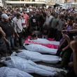 Mourners gather around the bodies of Palestinian men who were killed in an Israeli airstrike in Deir al-Balah, Gaza, Sunday, Oct. 6, 2024. (AP Photo/Abdel Kareem Hana)