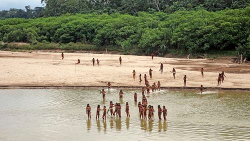 This June 2024 photo provided by Survival International shows members of the Mashco Piro along the Las Piedras River in the Peruvian Amazon near the community of Monte Salvado, in Madre de Dios province, Peru. (Survival International via AP)