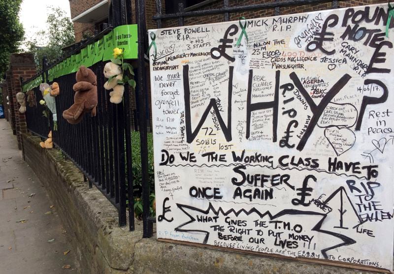 FILE - Tributes are tied to a fence, Thursday, June 14, 2018, in support of those affected by the massive fire in Grenfell Tower in London. (AP Photo/Kirsty Wigglesworth, File)