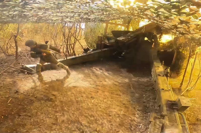 In this photo taken from a video released by Russian Defense Ministry press service on Thursday, Sept. 26, 2024, A Russian serviceman fires Giatsint-B gun towards Ukrainian positions at an undisclosed location in Ukraine. (Russian Defense Ministry Press Service via AP)