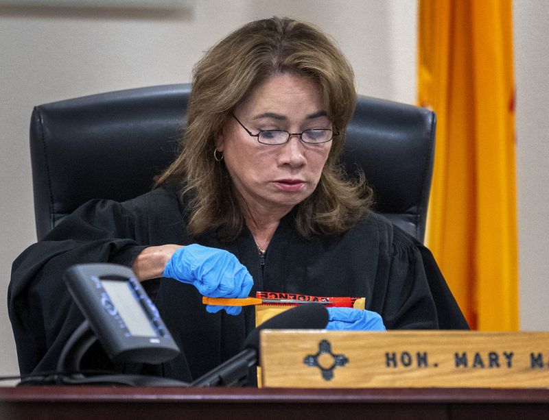 Judge Mary Marlowe Sommer opens a package of evidence not turned over to defense attorneys during actor Alec Baldwin's trial for involuntary manslaughter for the 2021 fatal shooting of cinematographer Halyna Hutchins during filming of the Western movie "Rust," Friday, July 12, 2024, in Santa Fe, N.M. (Eddie Moore/The Albuquerque Journal via AP, Pool)