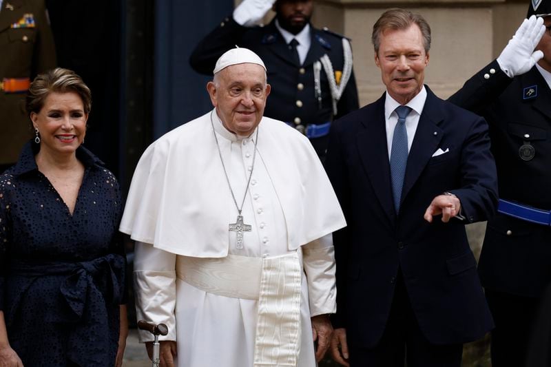 Pope Francis is welcomed by Grand Duchess Maria Teresa, left, and Luxembourg's Grand Duke Henri, right, at the Grand Ducal Palace in Luxembourg, Thursday, Sept. 26, 2024. (AP Photo/Omar Havana)