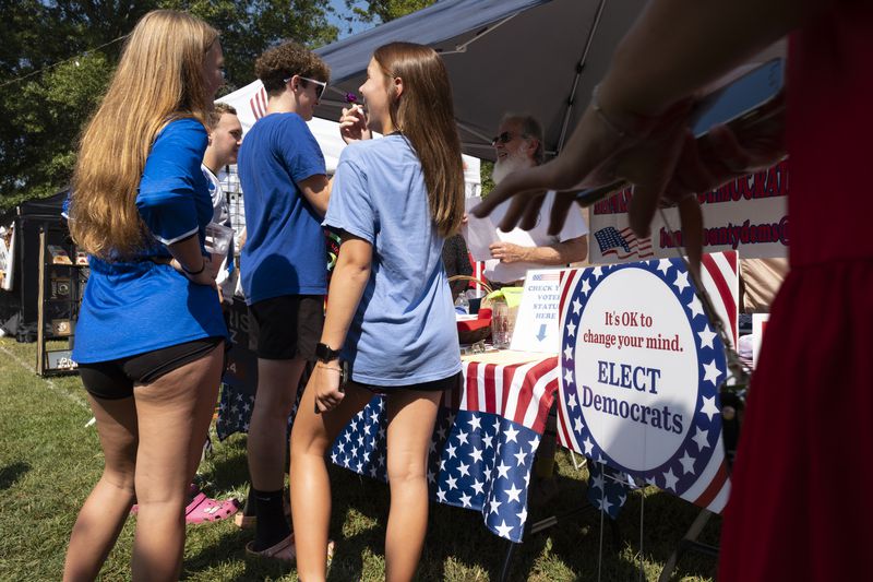 Youths gather around a Banks County Democratic Party booth during the Labor Day Festival in Homer on Aug. 31. (Ben Gray / Ben@BenGray.com)